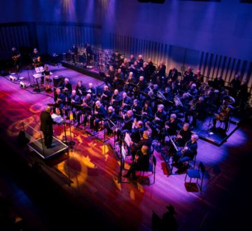 SENIORENORKEST TILBURG | Het orkest bestaat uit zo‘n 50 enthousiaste muzikanten die gevarieerde muziek brengen bij verschillende gelegenheden, vaak in samenwerking met andere orkesten, koren, etc. Om de paar jaar organiseren we een cross-over concert met een specifiek thema en gast orkest. Onlangs bv een ”country en western” concert in samenwerking met de Tilburgse c&w band Savannah.